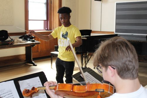Jahshanti leading his fellow ECMS students in a string ensemble