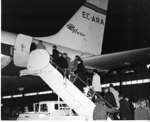 Members of the Eastman Philharmonia boarding their chartered plane at Idlewild Airport to begin their three-month tour. Photos by Louis Ouzer.