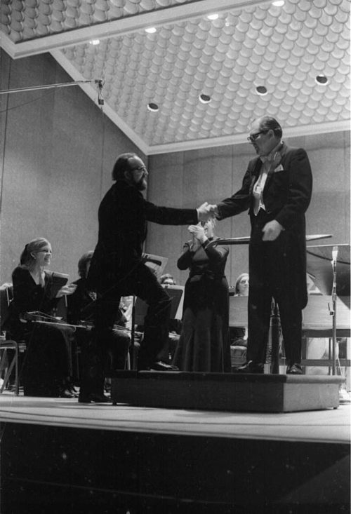 Eastman Philharmonia concert that featured the premiere of Krzystof Penderecki’s Partita for Harpsichord and Orchestra. At the conclusion of the Partita, Maestro Hendl invites the composer to the stage for bows. In the last shot, the composer, the soloist, and the conductor all join hands to acknowledge the applause.