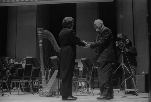 Howard Hanson greets Donald Hunsberger and acknowledges the audience’s applause on the occasion of the Eastman Wind Ensemble’s premiere performance of his Dies Natalis II, April 7th, 1972.