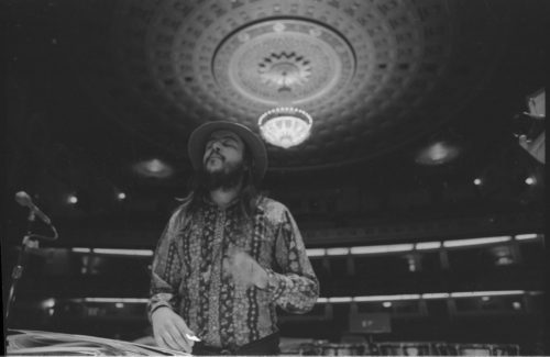 Chuck Mangione on the podium in the Eastman Theater, captured by Louis Ouzer during a rehearsal. This striking sequence is emblematic of Mr. Ouzer’s penchant of capturing conductors on the podium with the visually imposing chandelier in the background.