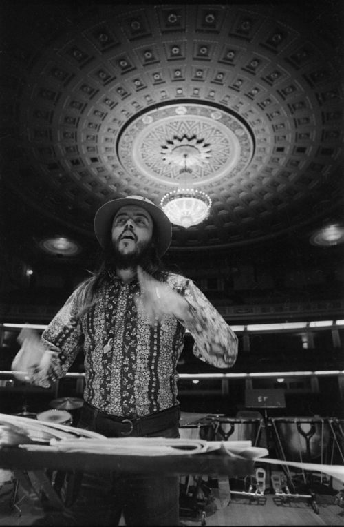 Chuck Mangione on the podium in the Eastman Theater, captured by Louis Ouzer during a rehearsal. This striking sequence is emblematic of Mr. Ouzer’s penchant of capturing conductors on the podium with the visually imposing chandelier in the background.