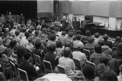 Violinist Isaac Stern working with an Eastman violin student during a master class in Room 120