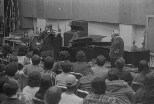 Violinist Isaac Stern working with an Eastman violin student during a master class in Room 120