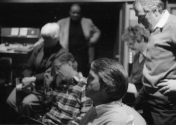 Principals gather in the control room to hear playbacks. Variously seen in these shots are conductor Donald Neuen, producer Ray Wright, recording engineer Ros Ritchie, harpsichordist Arthur Haas, and several of the vocal soloists.