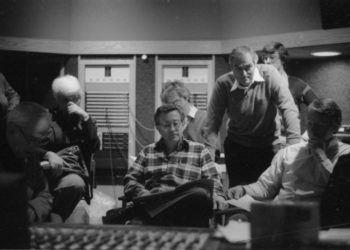 Principals gather in the control room to hear playbacks. Variously seen in these shots are conductor Donald Neuen, producer Ray Wright, recording engineer Ros Ritchie, harpsichordist Arthur Haas, and several of the vocal soloists.