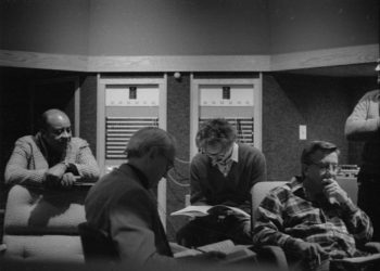Principals gather in the control room to hear playbacks. Variously seen in these shots are conductor Donald Neuen, producer Ray Wright, recording engineer Ros Ritchie, harpsichordist Arthur Haas, and several of the vocal soloists.
