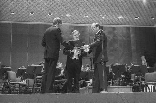 Dr. Donald Hunsberger, conductor of the Eastman Wind Ensemble since 1964, is presented with the National Band Association Academy of Wind and Percussive Arts Society Award by Edward Lisk, President of the NBA.