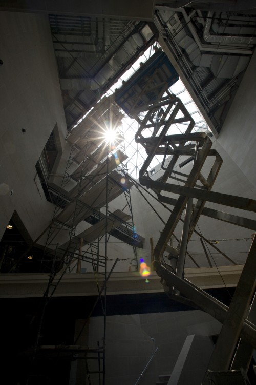Workers prepare the support system for the installation of a sculpture