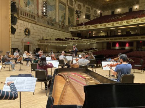 Austin Chanu rehearsing Banner with the Philharmonia strings in Kodak Hall